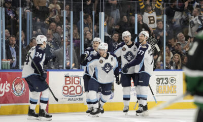 The Milwaukee Admirals celebrate scoring a goal against the Texas Stars.